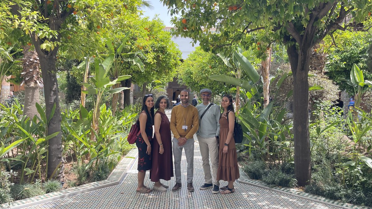 Travelers walking through a Moroccan garden