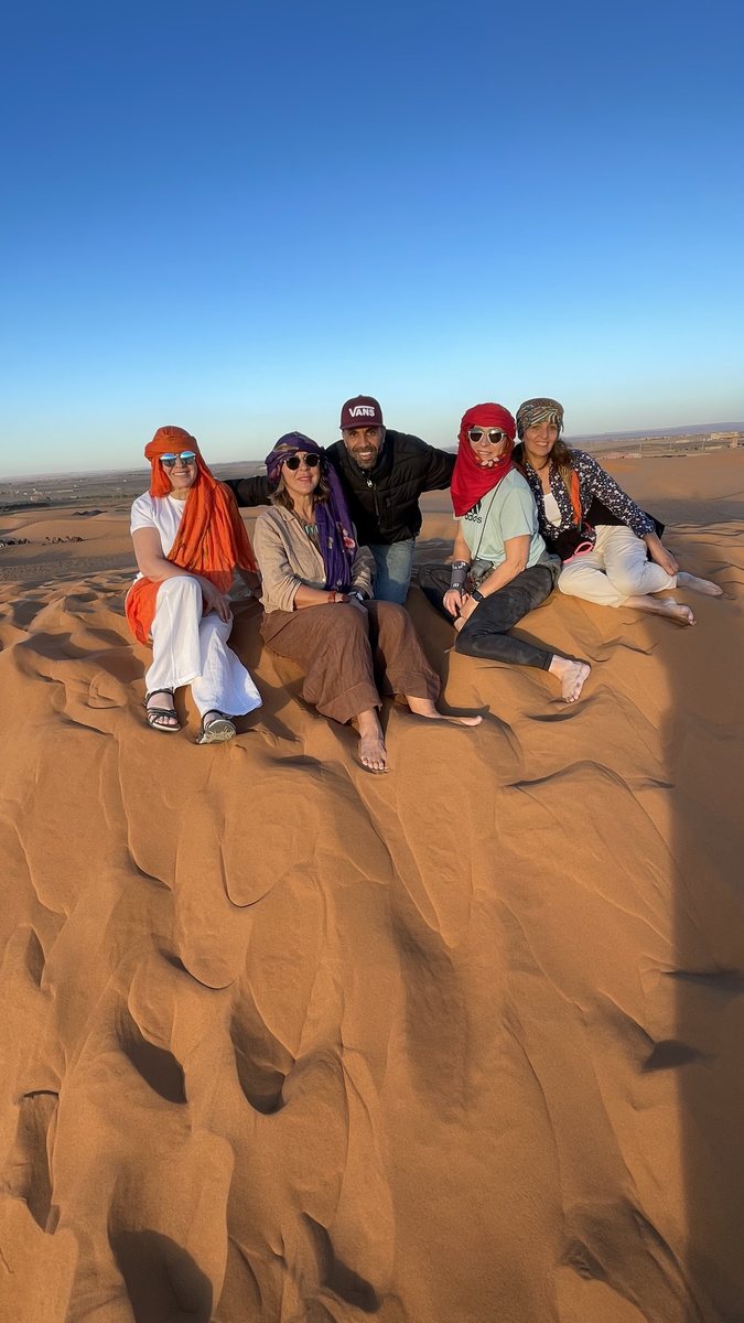 Travelers on Sahara desert dunes